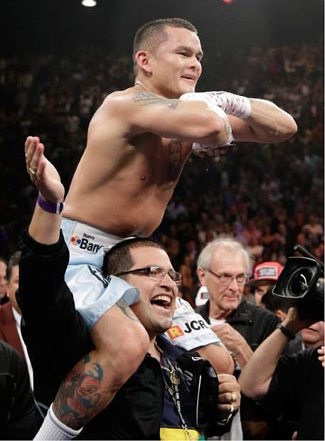 Marcos Maidana, from Argentina, celebrates at the end of his WBC-WBA welterweight title boxing fight against Floyd Mayweather Jr., Saturday, May 3, 2014, in Las Vegas.  Mayweather won the bout by majority decision. (AP Photo/Isaac Brekken)