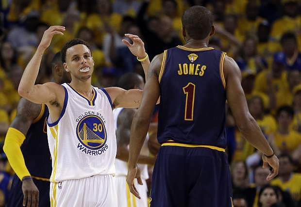 Golden State Warriors guard Stephen Curry (30) reacts next to Cleveland Cavaliers forward James Jones (1) during the second half of Game 1 of basketball&#039;s NBA Finals in Oakland, Calif., Thursday, June 4, 2015. (AP Photo/Ben Margot)