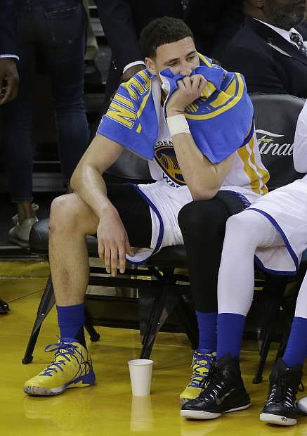Golden State Warriors guard Klay Thompson sits on the bench during the second half of Game 5 of basketball&#039;s NBA Finals against the Cleveland Cavaliers in Oakland, Calif., Monday, June 13, 2016. The Cavaliers won 112-97. (AP Photo/Eric Risberg)
