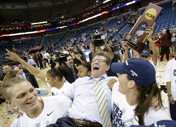 Connecticut players celebrate as they carry head coach Geno Auriemma off the court after defeating Louisville 93-60 in the national championship game of the women&#039;s Final Four of the NCAA college basketball tournament, Tuesday, April 9, 2013, in New Orleans.