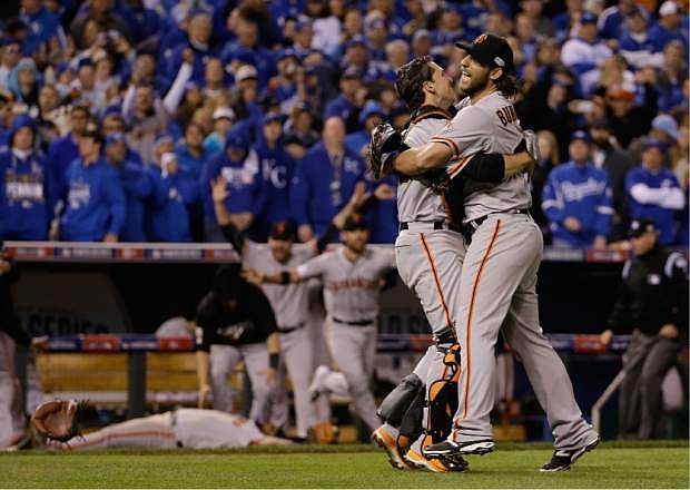 San Francisco Giants&#039; Madison Bumgarner and catcher Buster Posey celebrate after Game 7 of baseball&#039;s World Series against the Kansas City Royals Wednesday, Oct. 29, 2014, in Kansas City, Mo. The Giants won 3-2 to win the series.  (AP Photo/David J. Phillip)