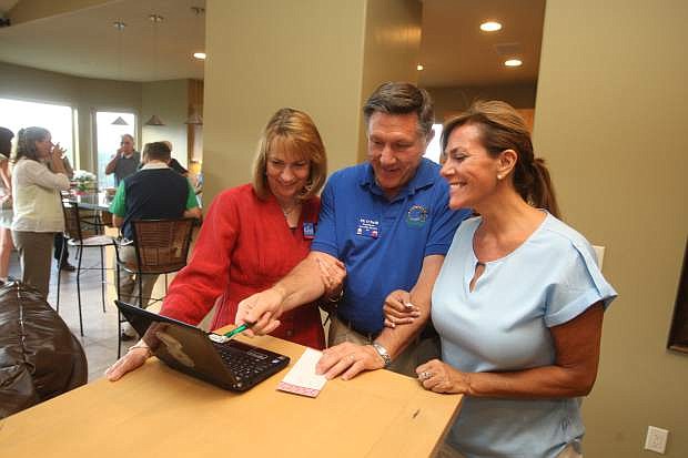 State Assembly District 40 Republican candidate Phillip &quot;PK&quot; O&#039;Neill views early election results with his wife Nancy, left, and campaign director Jennifer Russell on Tuesday night.