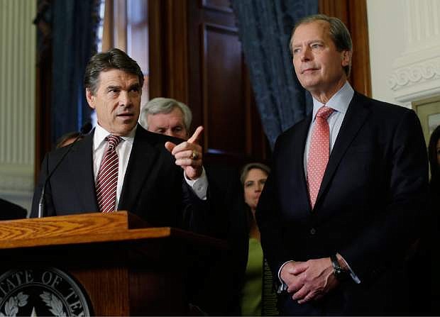 In this May 28, 2013 file photo, Lt. Gov. David Dewhurst , right, stands with Gov. Rick Perry during the signing of a water fund bill, in Austin, Texas. Now that the governor has called a special session, Dewhurst will get a chance to resurrect the anti-abortion legislation bill that failed earlier this week, but maybe not his political career.  (AP Photo/Eric Gay)