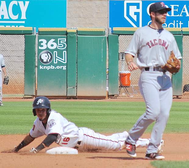Reno&#039;s Ildemaro Vargas slides safely ahead of the throw to Tacoma&#039;s second baseman, Mike Freeman, during Sunday&#039;s Triple-A game.