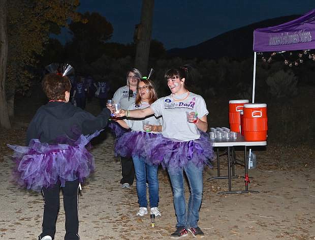 &#039;Water Girls&#039; Samantha Fishburn, Laura Kauf and Rebecca Singleton hand-up water to runners and walkers Saturday evening at Riverview Park.