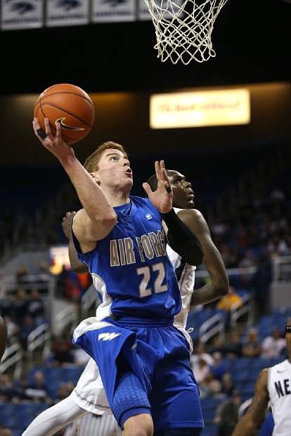 Air Force&#039;s Max Yon (22) shoots past Nevada defender Jerry Evans Jr. during an NCAA college basketball game in Reno, Nev., Saturday, Feb. 1, 2014. Nevada won 69-56 in overtime. (AP Photo/Cathleen Allison)