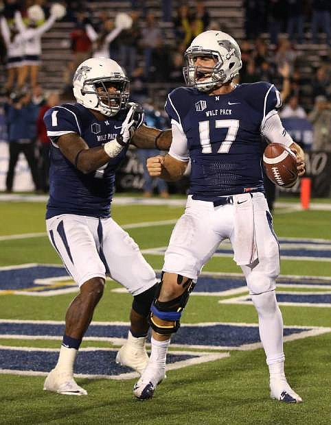 Nevada&#039;s Cody Fajardo (17) celebrates with Brandon Wimberly (1) after scoring the game-winning touchdown against Air Force during the second half of an NCAA football game in Reno, Nev., on Saturday, Sept. 28, 2013. Nevada won 45-42. (AP Photo/Cathleen Allison)