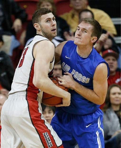 UNLV forward Ben Carter, left, and Air Force guard Zach Kocur vie for the ball during the first half of an NCAA college basketball game Saturday, in Las Vegas.
