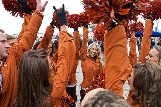 The Texas Longhorns cheerleaders do the perfect cheer before the team enters the stadium for the Valero Alamo Bowl in San Antonio, Texas, at the Alamodome, Mon, Dec 30, 2013. (AP Photo/The Oregonian, Thomas Boyd)