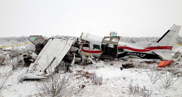 This image provided Saturday Nov. 30, 2013, courtesy of Alaska State Troopers shows the wreckage of a plane that crashed Friday near St. Marys, Alaska. Authorities said the pilot and three passengers died in this crash of the single-engine turboprop Cessna 208.  Few other details, including the possible cause of the crash, are known. (AP Photo/Alaska State Troopers()