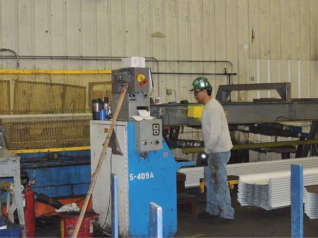 Jose Nunez is a 20 year employee of American Buildings Company. Here he is seen operating machinery for the company on Friday.