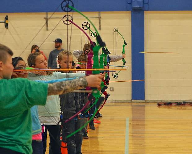 National Archery in the Schools Program (NASP) competitors take aim and fire at targets in the Carson High small gymnasium Saturday.