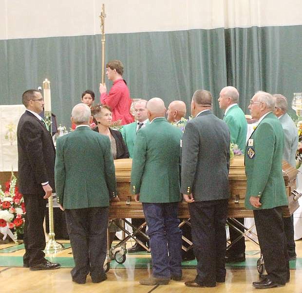 Pall bearers prepare to move the casket of Edward Arciniega after a funeral mass on Saturday