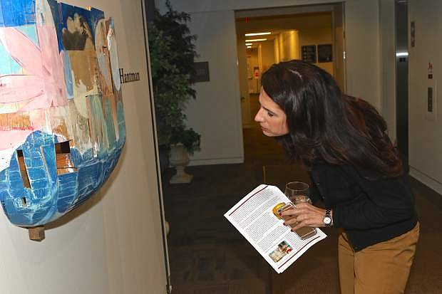 Adriana Fralick admires the art of Jeff Hantman Friday evening at the CCAI Courthouse Gallery.