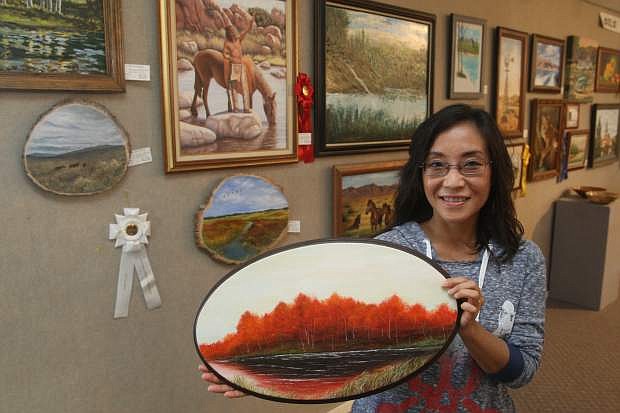Artist Alice Winslow displays her oil on wood painting titled &quot;Birch in Fall&quot;. Winslow is one of many artists with work on display at the Nevada Day Art Show.