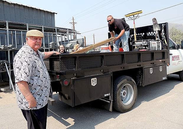 Donn Simon, Artistic Fence founder, pays a visit to his firm and family members as they work. Behind the truck are, from left, Jessica and Joanne Dietrich, as JoeDonn Dietrich handles matters in the truck&#039;s bed.