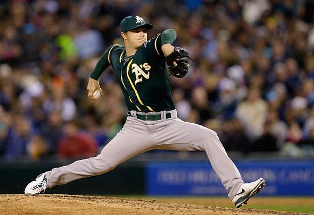 Oakland Athletics starting pitcher Sonny Gray throws against the Seattle Mariners in the sixth inning of a baseball game, Saturday, April 12, 2014, in Seattle. (AP Photo/Ted S. Warren)