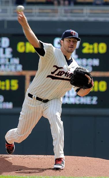Minnesota Twins pitcher Phil Hughes throws against the Oakland Athletics during the first inning of a baseball game in Minneapolis, Wednesday, April 9, 2014. (AP Photo/Tom Olmscheid)