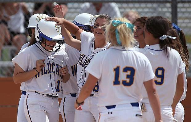 Western Nevada College&#039;s Katilyn Covione is congratulated by teammates after hitting a two-run homer against the College of Southern Nevada on Friday, May 2, 2014, in Carson City, Nev.