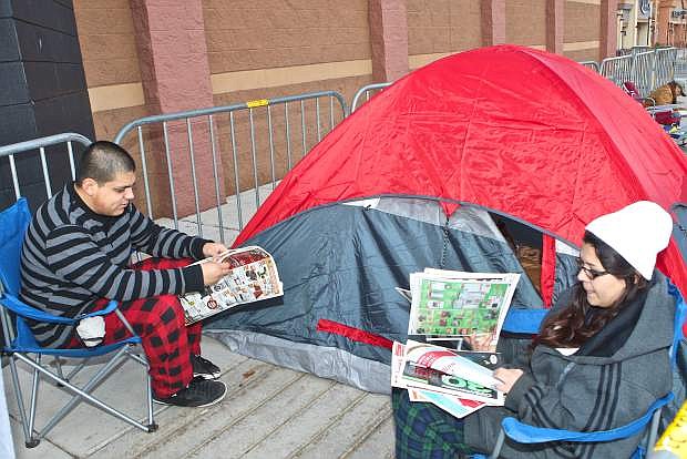 Isay Lamas, left, and his girlfriend Karla Mariscal, right, of Carson City camped out in front of Best Buy overnight with hopes of purchasing a bargain 50-inch Panasonic TV on Thursday.