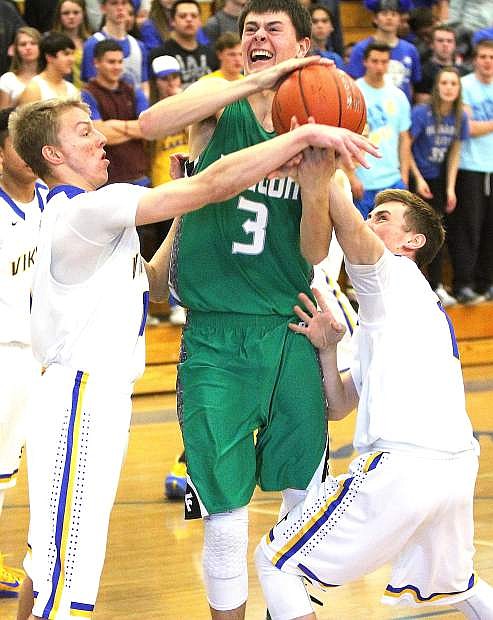 Fallon&#039;s Clay Davison, middle, fights off a pair of South Tahoe defenders during the Wave&#039;s 60-44 win on Saturday to clinch a playoff berth.