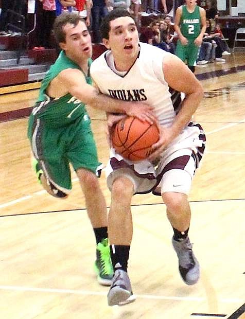 Fallon&#039;s Marshall Coverston gets a hand on the ball as Elko&#039;s Nathan Klekas attempts to drive to the basket.