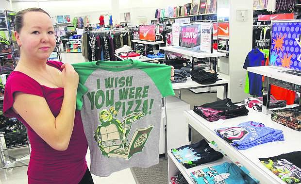 Crystal Verudgo looks at clothing on Thursday for her 10-year-old son at Bealls.