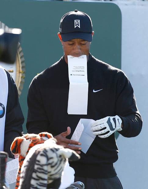 Tiger Woods prepares on the first tee for the final round of the BMW Championship golf tournament at Conway Farms Golf Club in Lake Forest, Ill., Monday, Sept. 16, 2013. (AP Photo/Charles Rex Arbogast)