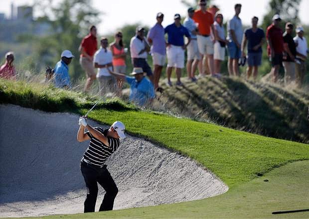 Gary Woodland hits from a trap on the 15th hole during the third round of The Barclays golf tournament Saturday, Aug. 24, 2013, in Jersey City, N.J. (AP Photo/Mel Evans)