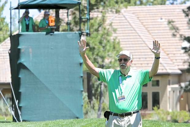 David Knighton raises his arms to quiet the gallery Thursday on the 14th green.