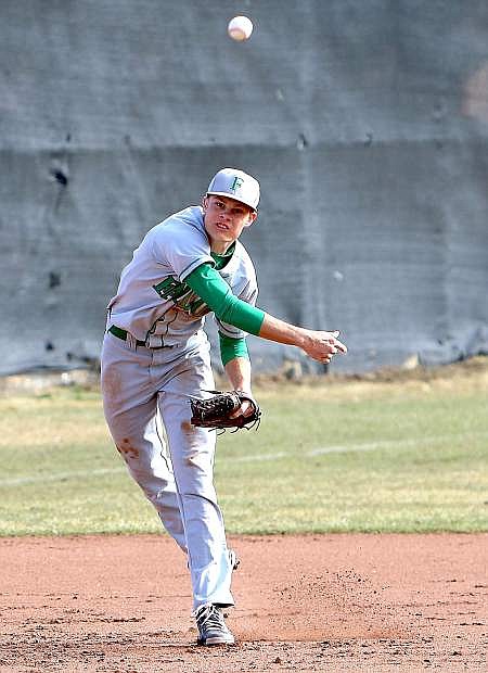 Fallon third baseman Riley Williams throws out a runner during Friday&#039;s 15-10 win at Truckee. The Greenwave swept the Wolverines in their three-game series.