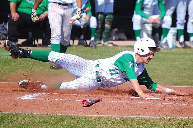 Fallon senior Dalton Frank slides safely into home during Fallon&#039;s 12-9 loss to Elko on Saturday. Despite the loss, Fallon won the series to take a commanding lead in the Northern Division I-A.