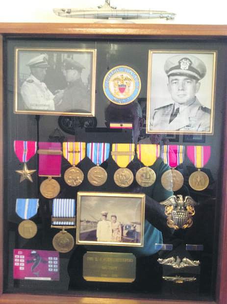The picture in the upper left is Rear Admiral Lockwood pinning the Bronze Star on Chief Delmar J. Schwichtenberg. The first red ribbon with the vertical blue strip on the left in the top row of ribbons is Del Bronze Star.
