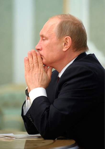 Russian President Vladimir Putin attends a meeting of the Eurasian Economic Council in Minsk, Belarus, Tuesday, April 29, 2014. (AP Photo/RIA-Novosti, Alexei Druzhinin, Presidential Press Service)
