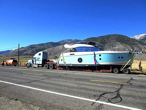 A 50-foot yacht sits alongside Highway 88 on Sunday awaiting an escort from California Highway Patrol to Lake Tahoe.