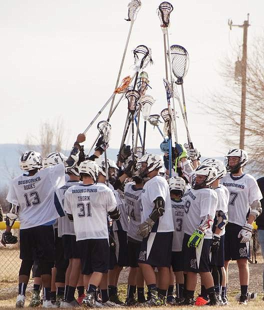 The Bighorns Lacrosse team rally after their win against Reed High School.