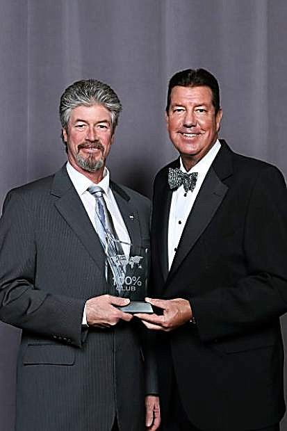 Stephen Lincoln recently accepted the RE/MAX 100% Club Award from Vinnie Tracy, president of RE/MAX International.