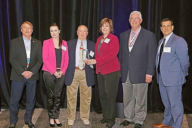 Representatives from Nevada Rural Housing Authority accept awards for excellence in two categories.