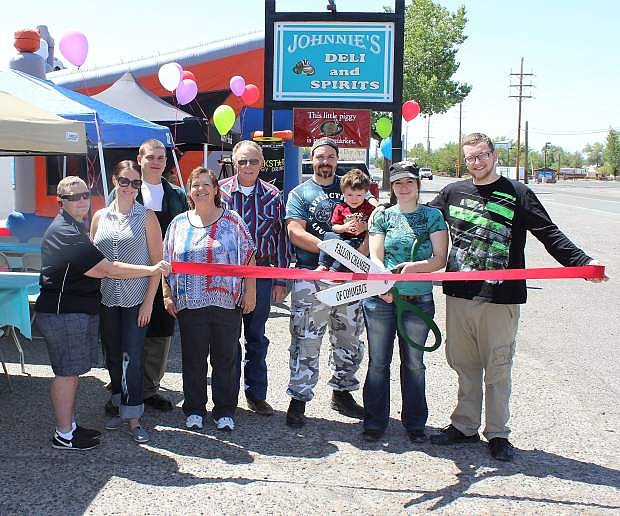 Johnnie&#039;s Deli &amp; Spirits held a ribbon cutting on Saturday. From left are Eva Case, Chamber of Commercemember; Natalie Parrish, Chamber of Commerce executive director; Damien Grimes; Pam Miller; Larry Miller; Johnnie Miller with Styrr; Tawny Bowman; and Sam Mosser with the ribbon.