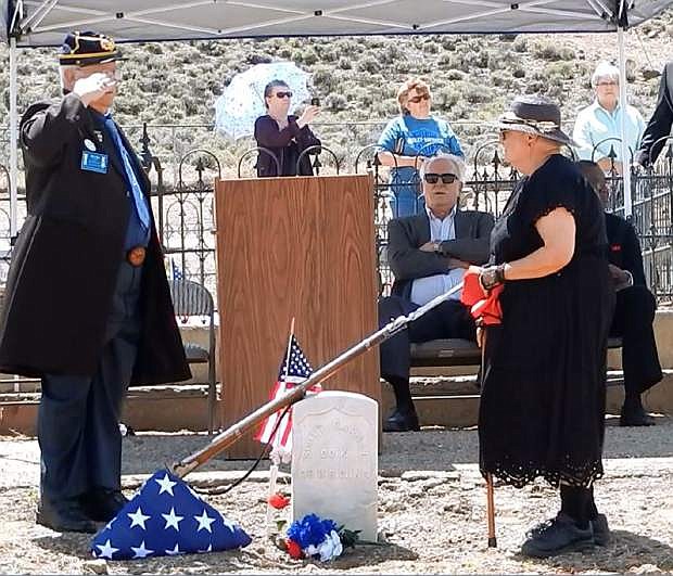 John Riggs of the Sons of Union Veterans of the Civil War, left, and Linda Clements of the Historical Society of Dayton Valley pay their respects to Pvt. Scott Carnal of the 1st Kansas Colored Infantry during a ceremony Sunday at his grave in Dayton. Carnal, a runaway slave who joined the Union Army during the Civil War and lost a leg after being wounded in battle, finally received recognition during a military funeral Sunday, nearly 100 years after he died in Nevada.