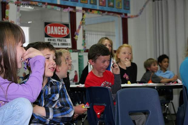 Students laugh at the early drawings of the main characters from the book &quot;Help Wanted at Mount Vernon.&quot; The students all participated in an after-school event at Fristch Elementary School Friday to celebrate the publication of the book.