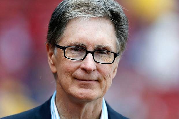 FILE - Boston Red Sox owner John Henry stands on the field before a baseball game in Boston, in this May 11, 2013 file photo. The principal owner of the Boston Red Sox has entered into an agreement to buy The Boston Globe. The Globe says the impending purchase marks businessman John Henry&#039;s &quot;first foray into the financially unsettled world of the news media.&quot; It said early Saturday Aug. 3, 2013 the deal will give Henry the 141-year-old newspaper, its websites and affiliated companies. (AP Photo/Michael Dwyer, File)