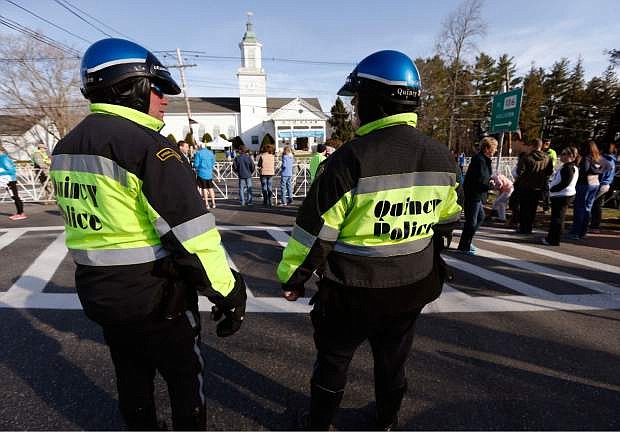 Quincy, Mass., police stand near the starting line of the 118th Boston Marathon Monday, April 21, 2014 in Hopkinton, Mass. (AP Photo/Michael Dwyer)