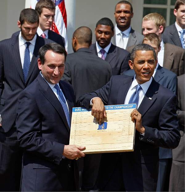 FILE - In this May 27, 2010 file photo, President Barack Obama looks over the bracket with coach Mike Krzyzewski of the NCAA basketball champion Duke Blue Devils in the Rose Garden of the White House in Washington, where he honored the team. The odds of completing the perfect bracket by picking the higher-seeded team are 35 billion to 1.  (AP Photo/Alex Brandon, File)