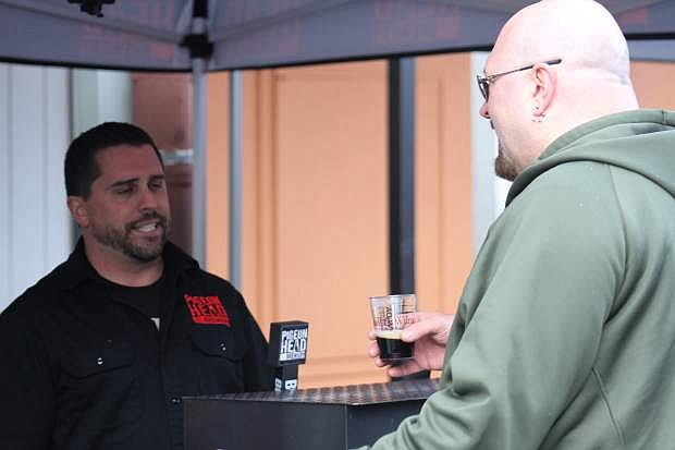 A brewer from Pigeon Head Brewery talks with a customer about his beer sample at the Legislative Brewfest in Carson City Wednesday. The event was free for the public and legislatures to sample nearly a dozen craft beers from around Nevada.