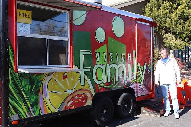 Pastor Randy Roser poses for a photo with The Bridge&#039;s food trailer Wednesday in Carson City. The trailer is open to feed the homeless from 5-6pm weekdays.