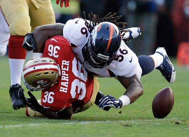 San Francisco 49ers running back D.J. Harper (36) fumbles the ball while being hit by Denver Broncos linebacker Nate Irving, right, during the second quarter of an NFL preseason football game on Thursday, Aug. 8, 2013, in San Francisco. Broncos&#039; Shaun Phillips recovered the ball for a touchdown. (AP Photo/Ben Margot)