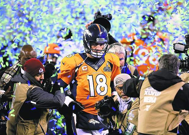 Broncos quarterback Peyton Manning exits the stadium after Sunday&#039;s Super Bowl loss to the Seahawks.