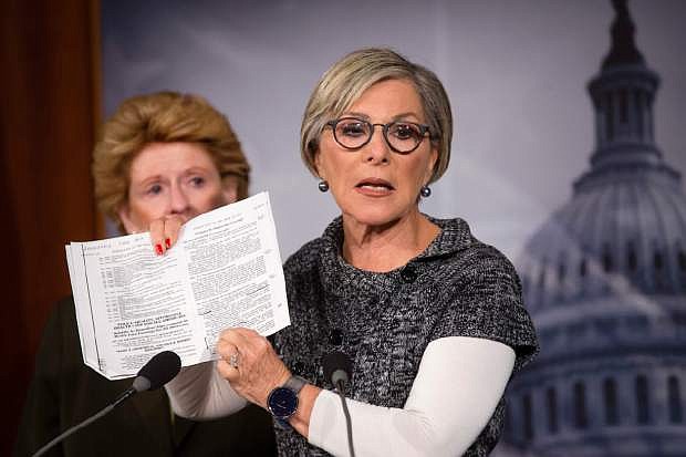 Sen. Barbara Boxer, D-Calif., right, holds up a passage from the Affordable Care Act concerning health care benefits for women as she tell reporters that House Republicans&#039; fight against it is tantamount to a war against women, Monday, Sept. 30, 2013, during a news conference on Capitol Hill in Washington. The Senate has the next move on must-do legislation required to keep the government open, and the Democratic-led chamber is expected to reject the latest effort from House Republicans to use a normally routine measure to attack President Barack Obama&#039;s signature health care law. Sen. Debbie Stabenow, D-Mich, listens at left. (AP Photo/J. Scott Applewhite)