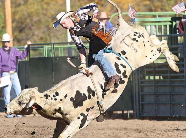 Bull rider Steven Vawter of Yerington hangs on during the Carl Howell Memorial Smackdown Saturday afternoon at Fuji Park. Proceeds from the event will be donated to fallen Deputy Howell&#039;s family.